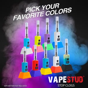 May include: A collection of colorful vape pens in various colors, including blue, yellow, purple, and white. Each pen is displayed on a matching colored stand. The text "PICK YOUR FAVORITE COLORS" is at the top, and "VAPESTUD STOP CLOGS" is at the bottom.