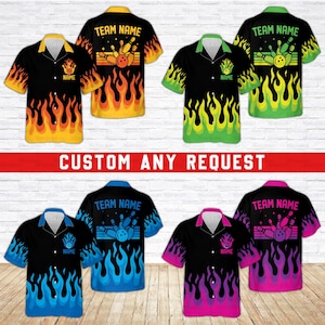 May include: Five different color variations of a bowling themed Hawaiian shirt. The shirts are black with flames in different colors, including yellow, green, blue, and pink. The shirts have a bowling pin and ball graphic with the text "TEAM NAME" and "NAME" on the front.