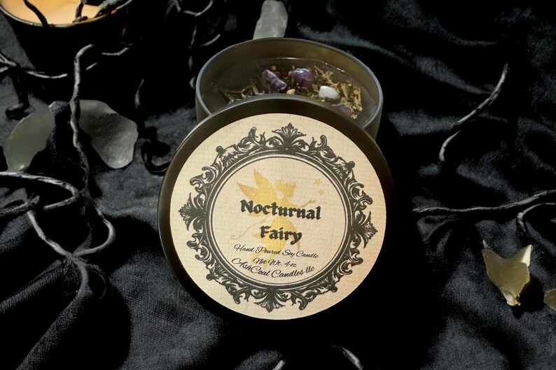 May include: A black candle jar with a gold label that reads "Nocturnal Fairy" Hand Poured Soy Candle Net Wt 4 oz.  Ash Coal Candles LLC.