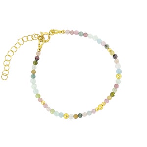 May include: A gold beaded bracelet with a variety of colorful gemstones, including pink, green, and blue. The bracelet has a lobster clasp closure.