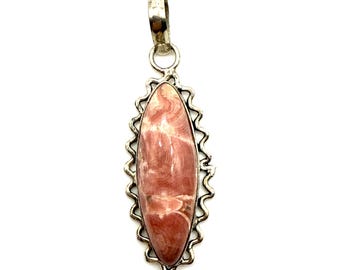 May include: A silver pendant with a pink and white oval-shaped stone set in a decorative silver frame.