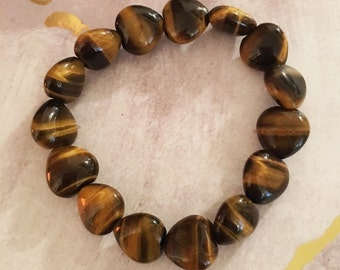 May include: A brown and gold tiger's eye gemstone bracelet with heart-shaped beads.