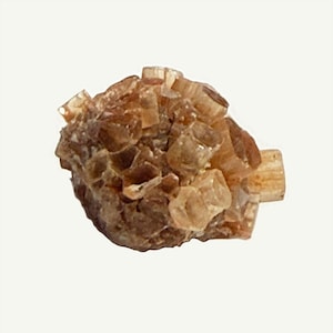 May include: A cluster of aragonite crystals, showcasing a warm, earthy palette of tan and brown hues. The crystals have a rough, textured appearance, with a natural, organic form. The mineral specimen is set against a plain white background.