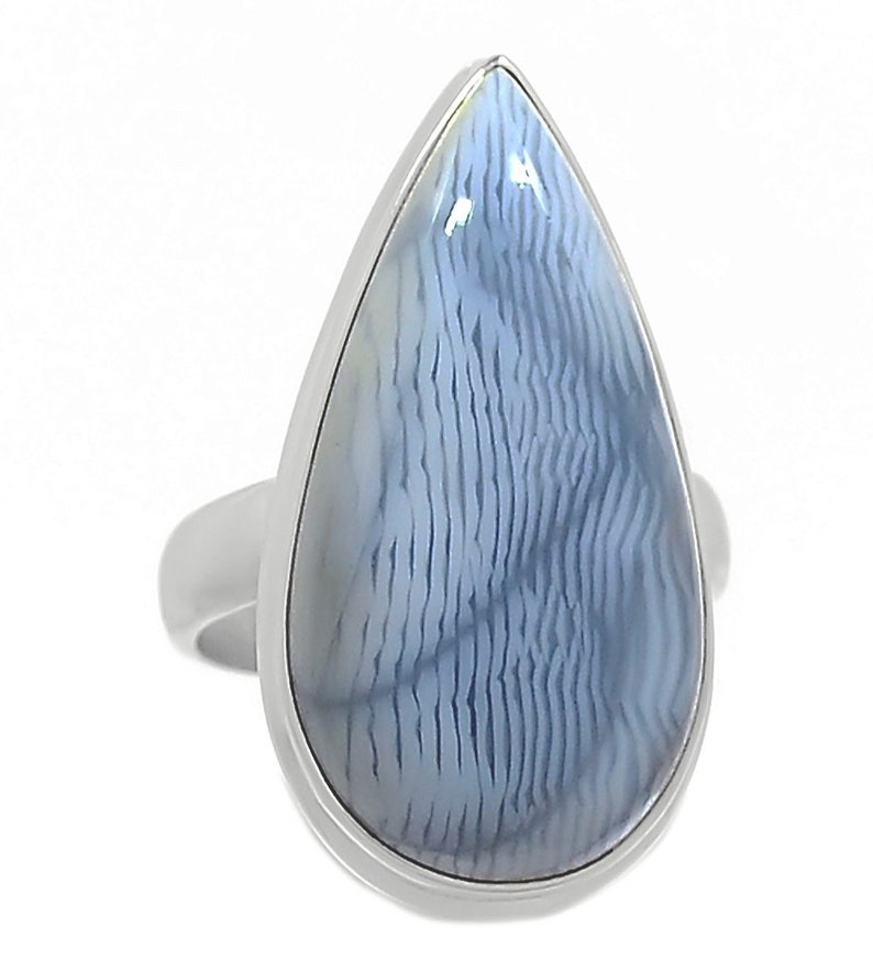 May include: A silver ring with a teardrop-shaped blue agate stone. The stone has a white and blue pattern.