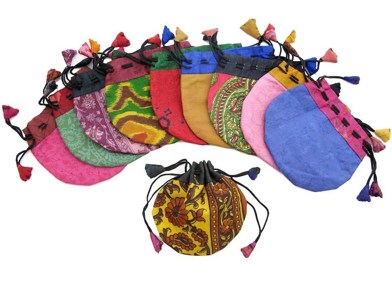 May include: A set of 11 colorful drawstring pouches with floral patterns. The pouches are made of fabric and have tassels.