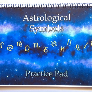 May include: A blue and purple galaxy-themed practice pad with gold astrological symbols. The title "Astrological Symbols" and the text "Practice Pad" are printed on the pad.