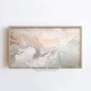 May include: Abstract art print with swirling patterns in shades of beige, brown, and gray. The print is framed in a light wood frame and has the text "BLUEBELL PRINTS Elegant Art Collective" at the bottom.