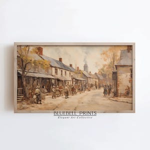 May include: A framed watercolor print depicting a historical street scene. The artwork features a bustling street with people, buildings, and trees in muted tones. The text "BLUEBELL PRINTS Elegant Art Collective" is visible at the bottom.