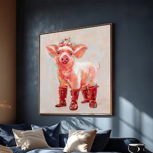 May include: A framed painting of a whimsical pig wearing red rain boots and a floral crown. The pig is pink and white with colorful paint splatters. The artwork is displayed on a wall above a blue sofa.