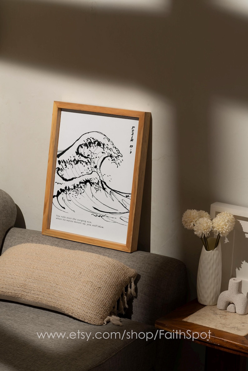 May include: A black and white print of a large wave with the text "You only see the surging sea, when its waves mount up, you still seem" in a wooden frame.