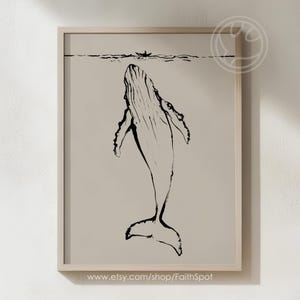 May include: A black and white line drawing of a whale swimming upwards in the ocean. The whale is facing the viewer with its mouth open. The drawing is on a beige background.