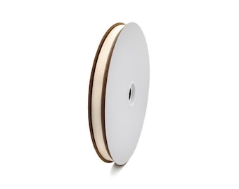 May include: A spool of cream-colored ribbon with a brown edge. The ribbon is tightly wound on a white cardboard spool. The ribbon is likely used for crafts, gift wrapping, or other decorative purposes.