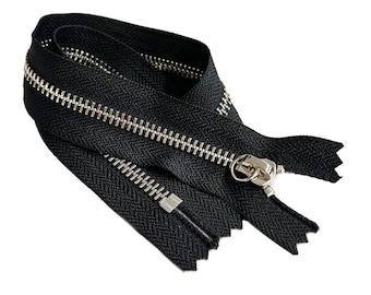 May include: Black zipper with silver metal teeth and a silver pull. The zipper is folded in half and the pull is at the top.
