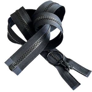 May include: Black zipper with a black metal slider and pull tab. The zipper is coiled and ready to be sewn into a garment.