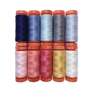 May include: A set of ten spools of thread in various shades of blue, pink, and white. The spools are labeled with the text "Ne 50" and "Italy".