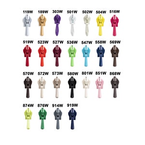 May include: Assortment of plastic zipper pulls in various colours, including white, black, red, green, blue, yellow, and brown. The zipper pulls are arranged in rows and labelled with numbers.
