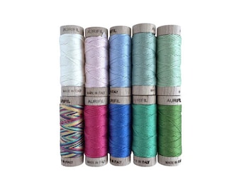 May include: A set of ten spools of Aurifil thread in various colors, including pink, blue, green, and red. The spools are labeled "Aurifil" and "Made in Italy".