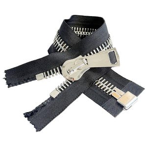 May include: A black zipper with silver teeth and a silver slider. The zipper is open and the two sides are lying next to each other.
