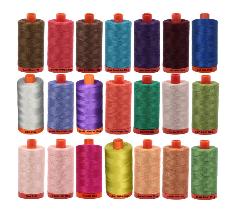 May include: A collection of 22 spools of thread in various colors, including dark olive, dark red orange, dark sandstone, dark turquoise, dark violet, dark wine, delft blue, dove, dusty blue violet, dusty lavender, dusty orange, emerald, emine, farm green, flesh, fleshy pink, fuchsia, gold yellow, golden honey, golden toast, and grass green. Each spool has a white label with the color name and number.