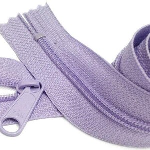 May include: A lavender zipper with a plastic slider. The zipper is closed and the tape is rolled up.