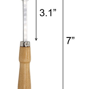 May include: A silver and wood rotary cutter with a wooden handle. The cutter is 7 inches long and the wheel is 3.1 inches in diameter.