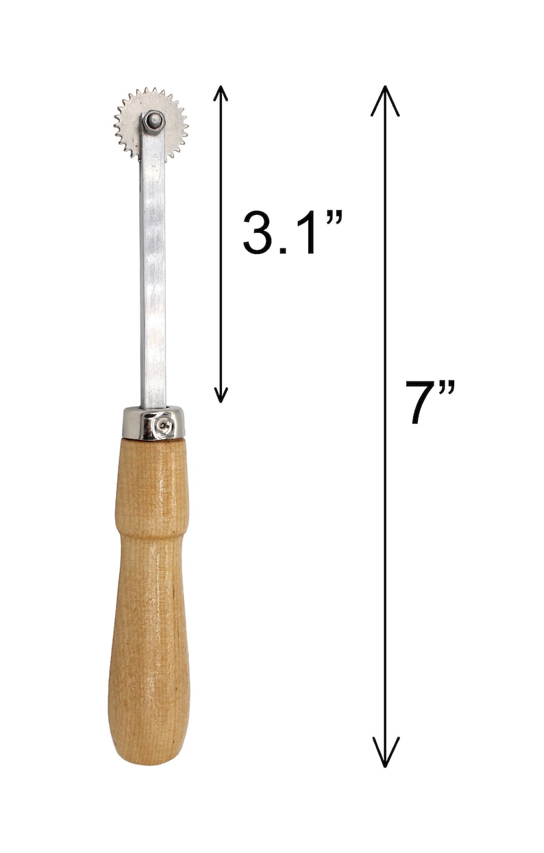 May include: A silver and wood rotary cutter with a wooden handle. The cutter is 7 inches long and the wheel is 3.1 inches in diameter.