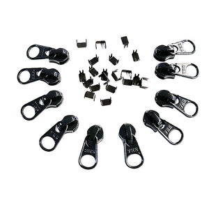 May include: A set of black zipper pulls with metal slider heads and a set of metal zipper stops. The zipper pulls are arranged in a circle around the zipper stops.