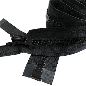 May include: Black zipper with a black plastic slider. The zipper is closed and the slider is in the middle of the zipper.