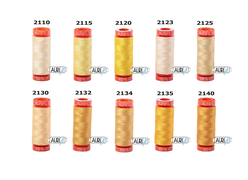May include: Ten spools of Aurifil thread in various shades of yellow and cream. The spools are labelled with the Aurifil logo and the thread number.