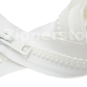 May include: White zipper tape with a white zipper pull. The zipper tape is folded in half and the zipper pull is at the top of the tape.