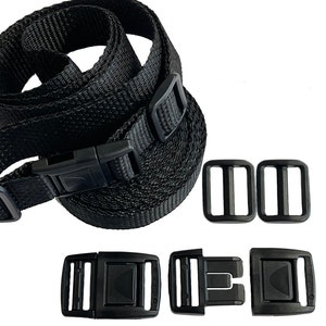May include: Black nylon straps with black plastic buckles and sliders. The straps are coiled and the buckles are laid out separately.