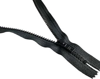May include: A black zipper with a metal slider. The zipper is open and the teeth are visible.