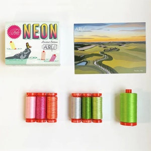 May include: A set of 10 spools of Aurifil thread in neon colors. The spools are arranged in two rows of five. The spools are labeled with the Aurifil logo and the color name. The spools are packaged in a box with a hippopotamus illustration and the text "Neon Limited Edition Aurifil".