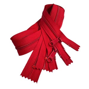 May include: Several bright red zippers are displayed against a white background. The zippers are open, showing the teeth and pull tabs. The zippers are made of a durable material and are suitable for various sewing projects.