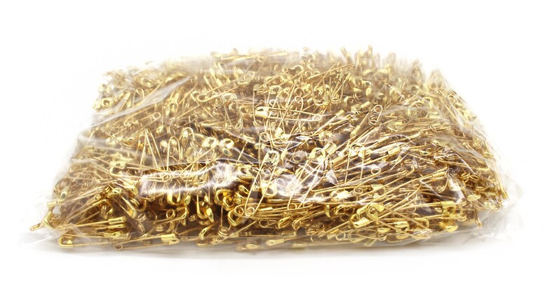 May include: A large plastic bag filled with gold safety pins.