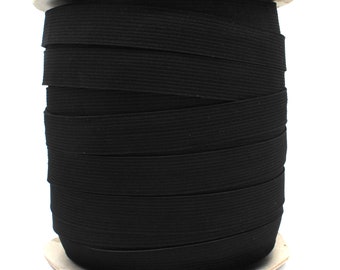 May include: A spool of black elastic band, wound around a cardboard core.