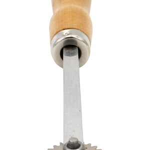 May include: A silver rotary cutter with a wooden handle. The cutter has a circular blade with a serrated edge.