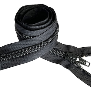 May include: Black zipper tape with a black zipper pull. The zipper tape is coiled and the zipper pull is open.