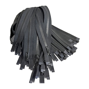 May include: A pile of black zippers with closed sliders and rectangular end pieces. The zippers are made of a durable material and are suitable for various sewing projects. The image is set against a white background.