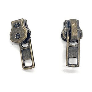 May include: Two antique gold zipper pulls with a metal slider. The top of the pull is a hexagonal shape with the number "8" and the letter "F" engraved on it.