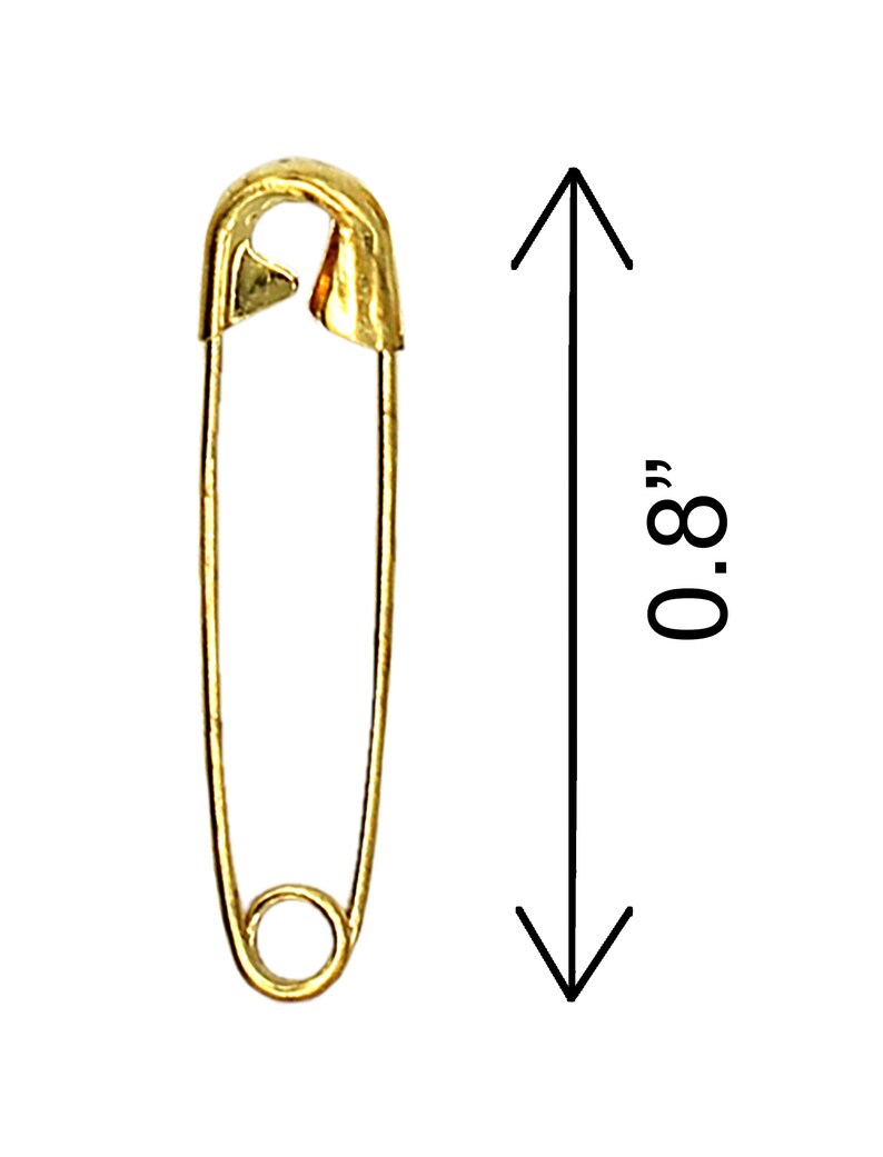 May include: A gold safety pin measuring 0.8 inches in length.