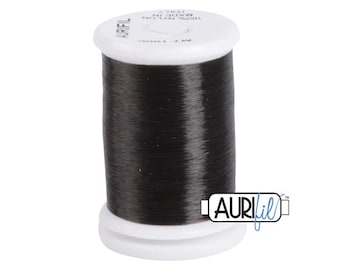 May include: A spool of black nylon thread, 100% nylon, made in Italy. The spool is labeled "Aurifil" and has a white label with the text "100% Nylon Made in Italy".