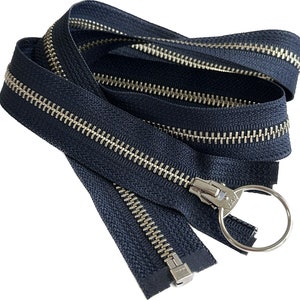 May include: A black zipper with silver teeth and a silver pull. The zipper is folded in half and the pull is at the top of the image.