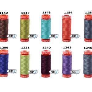 May include: A set of ten spools of Aurifil thread in various colours, including brown, green, blue, red, grey, purple, and teal. Each spool is labelled with the Aurifil logo and the thread number.