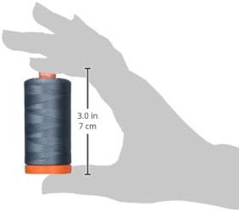 May include: A spool of dark gray thread with an orange bobbin, measuring 3 inches or 7 centimeters in height.