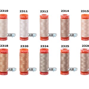May include: A set of ten spools of Aurifil thread in various shades of beige, cream, and light brown. The spools are labelled with the Aurifil logo and the thread number.
