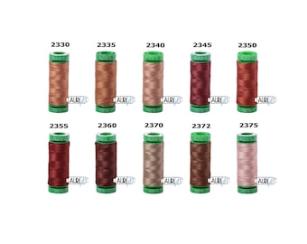 May include: A set of ten spools of Aurifil thread in various shades of brown, red, and pink. Each spool is labeled with the Aurifil logo and the thread number.