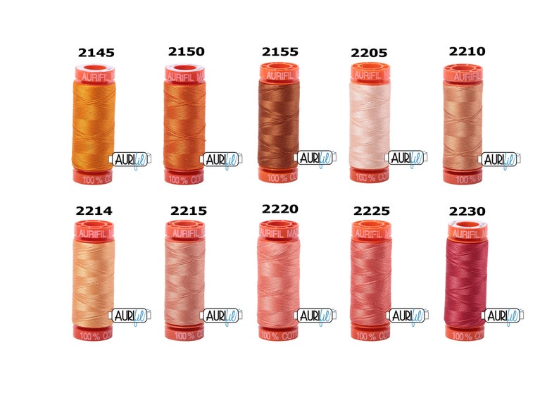 May include: Ten spools of Aurifil thread in various shades of orange, peach, and pink. The spools are labelled with the Aurifil logo and the thread number.