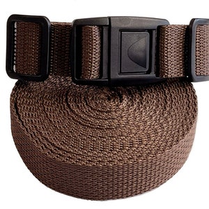May include: A brown nylon strap with a black plastic buckle. The strap is rolled up and the buckle is visible.