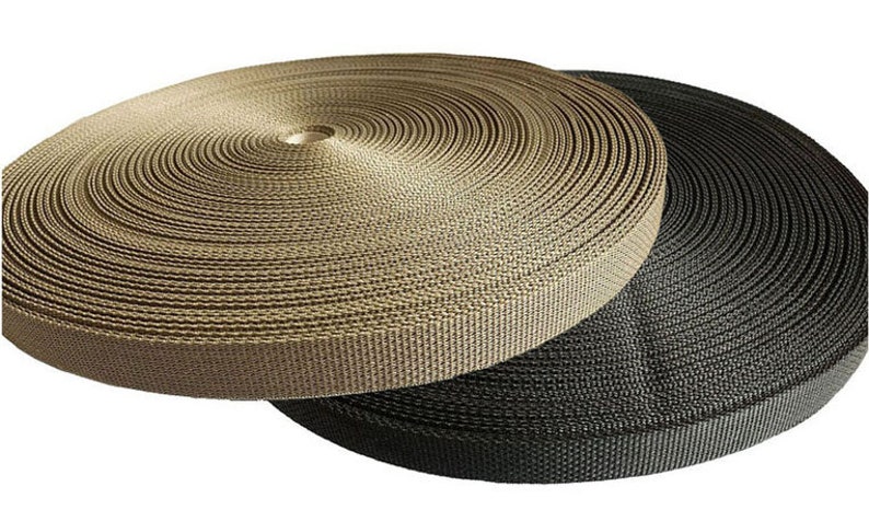 May include: Two spools of webbing, one in black and one in tan. The spools are wound tightly and are ready to be used for crafting or other projects.